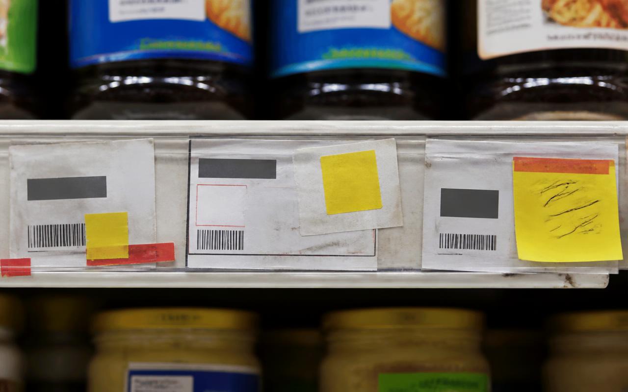 Supermarket shelf with printed paper price labels